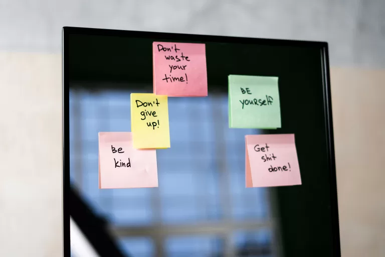 Pink Sticky Notes on Glass Mirror